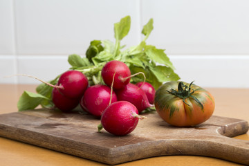 radish and tomato on cutting board
