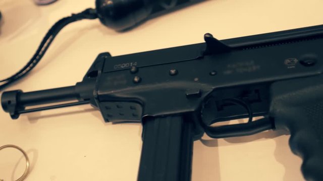 Compact and rapid-fire automatic gun for special forces on a white table