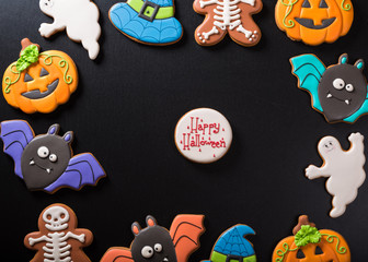 Funny delicious ginger biscuits for Halloween on the dark background.