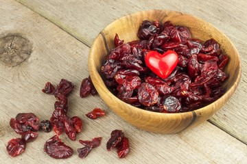 Dried cranberries in a bowl. Healthy superfood. Dried cranberries on the kitchen table. Diet food.
