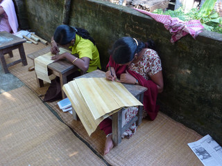 PURI, INDIA - NOV 15 -  Student practises engraved calligraphy on palm leaves   on Nov 15, 2009  in...