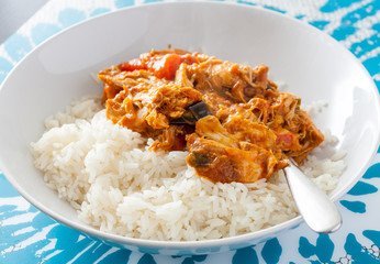 Ghanaian groundnut stew with long grain rice in a white bowl