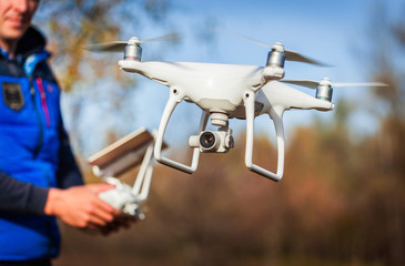 Man operating drone flying by remote control