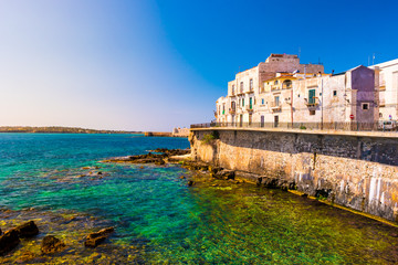 Fototapeta na wymiar Coast of Ortigia island at city of Syracuse, Sicily, Italy. Beautiful travel photo of Sicily.
