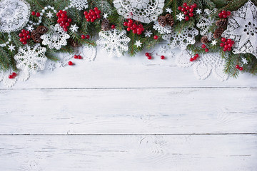 Christmas white wooden background with tree branches and red berries