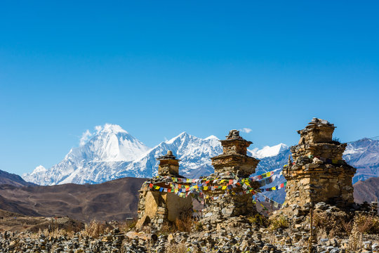 Buddhist chorten above Muktinath village, Dhaulagiri rising in the babkground.