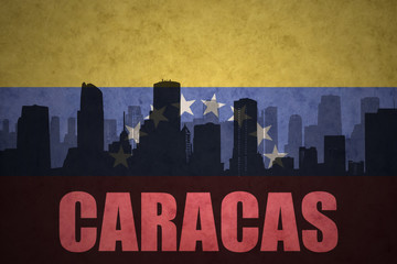 Fototapeta na wymiar abstract silhouette of the city with text Caracas at the vintage venezuelan flag