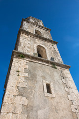 Fototapeta na wymiar Steeple of the Mother church of Santa Croce in Palomonte, southe
