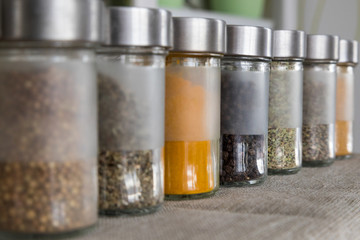 Spices, seasonings in small glass jars on pocket