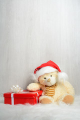Teddy bear in santa hat with gifts
