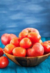 Fresh ripe wet red tomatoes in bowl