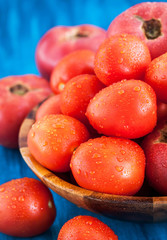 Fresh ripe wet red tomatoes in bowl