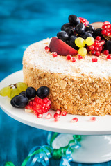 Delicious homemade honey cake decorated with fresh fruits