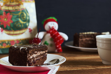 Chocolate cake with tea on gifts background. Small depth of field, toned image, selective focus