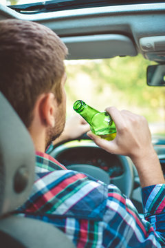 Man Drinking Alcohol While Driving The Car