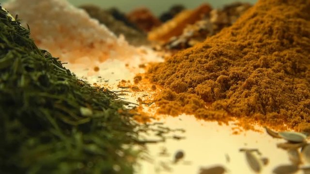 Fragrant, aromatic, natural and good for health, spices lie on the table, separately from each other.The camera moves through the spices. Closeup. Dolly shot. Shallow depth of field