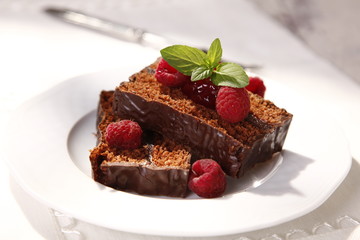 Fototapeta na wymiar gingerbread cake wrap chocolate with raspberry filling 