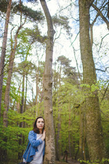 Fototapeta na wymiar Young girl on a walk in the forest