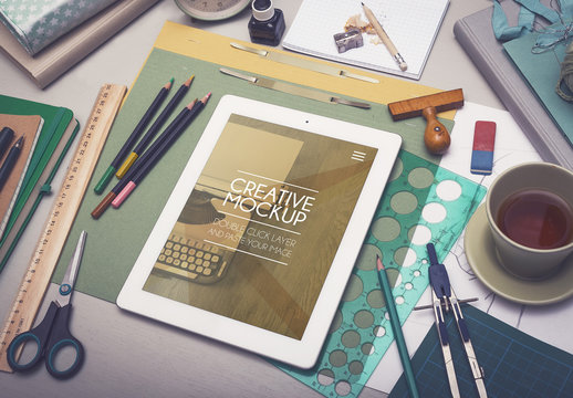 Tablet, Art, and Drafting Supplies on Desk Mockup