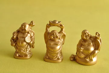 Poster Bouddha Figurines of a laughing and cheerful golden Buddhas