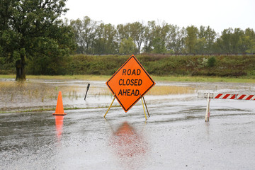 Road Closed Sign Warning of Rain Flooded Road