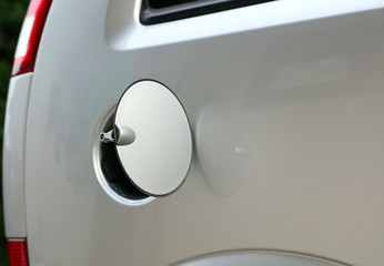 Opened gasoline tank cover on silver car