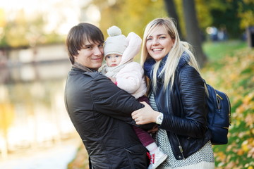 Leisure family with daughter in autumn park