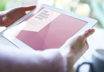 User with Tablet on Wooden Table in Soft Focus 3
