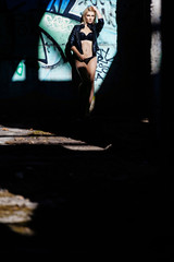 Blonde in underwear posing in concrete structure