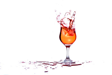Cocktail splashes as ice is thrown in