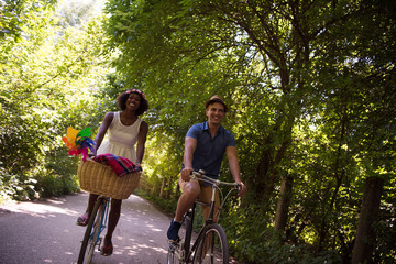 Obraz na płótnie Canvas Young multiethnic couple having a bike ride in nature
