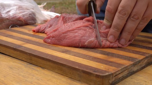 Man preparing meat for barbeque