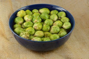 Brussel Sprouts soaking in bowl of water to loosen agricultural dirt