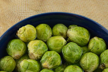 Brussel Sprouts soaking in bowl of water to loosen agricultural dirt