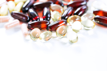 Vitamins, omega 3, cod-liver oil, dietary supplement and tablets an embankment on a light background close up, the top view