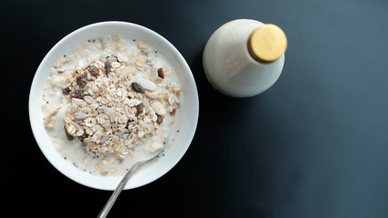 Morning granola breakfast with raisins and almond served with premium almond milk