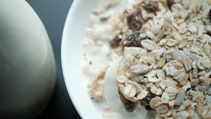 Morning granola breakfast with raisins and almond served with premium almond milk
