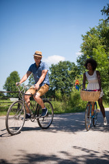 Young multiethnic couple having a bike ride in nature