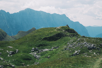 Fototapeta na wymiar Travelers or hikers in the mountains in the National Park Triglav, Slovenia