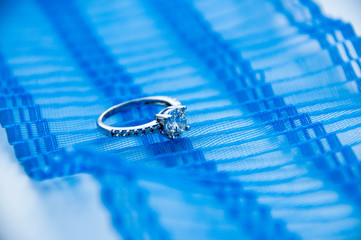 Silver ring with cubic zirconia on the blue ribbon  