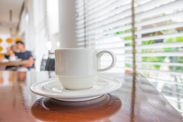 Coffee in white cup on wood table .
