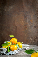 Fototapeta na wymiar Fresh tangerines on a napkin of coarse linen.