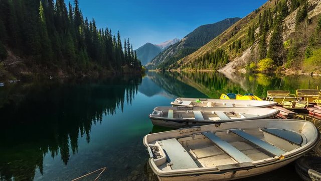 White wooden boat on the shore of Lake Kolsay. 4K TimeLapse - September 2016, Almaty and Astana, Kazakhstan