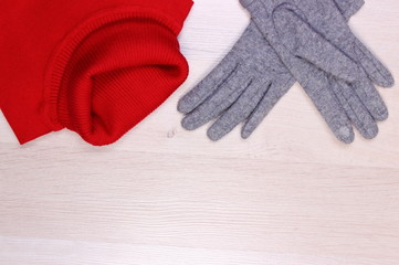 Womanly clothes on wooden background, copy space for text, clothing for autumn or winter