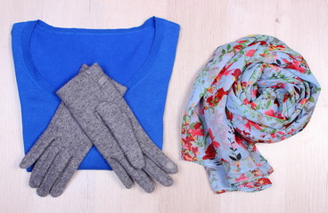 Womanly clothes on wooden background, clothing for autumn or winter