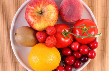 Naklejka na ściany i meble Fresh fruits and vegetables on plate, healthy nutrition