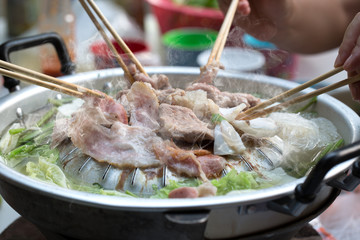 Enjoy family with Grilling sliced pork and meat on hot pan