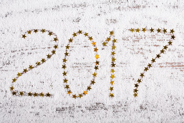 New Year background. Golden stars on snow backdrop.