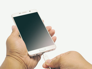 Smartphone on hand for pluging power charger, Isolated, Included