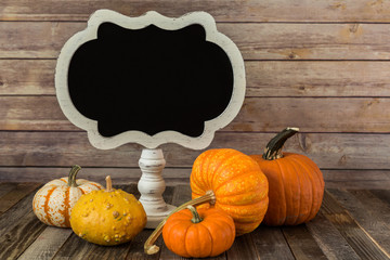 Blank chalkboard sign with decorative gourds